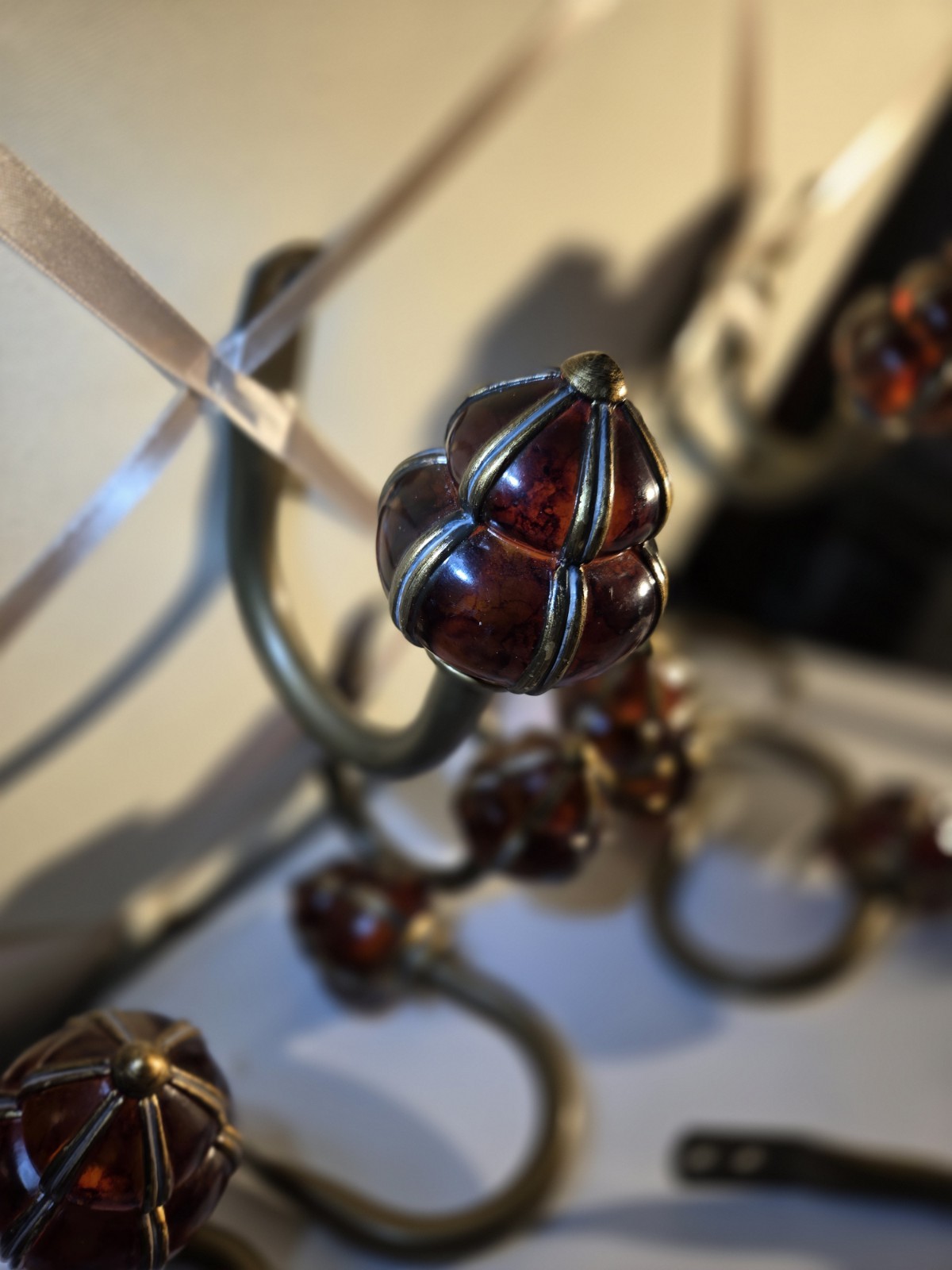 decorative wall curtain tie-back orange knob and a brass-finished metal arm