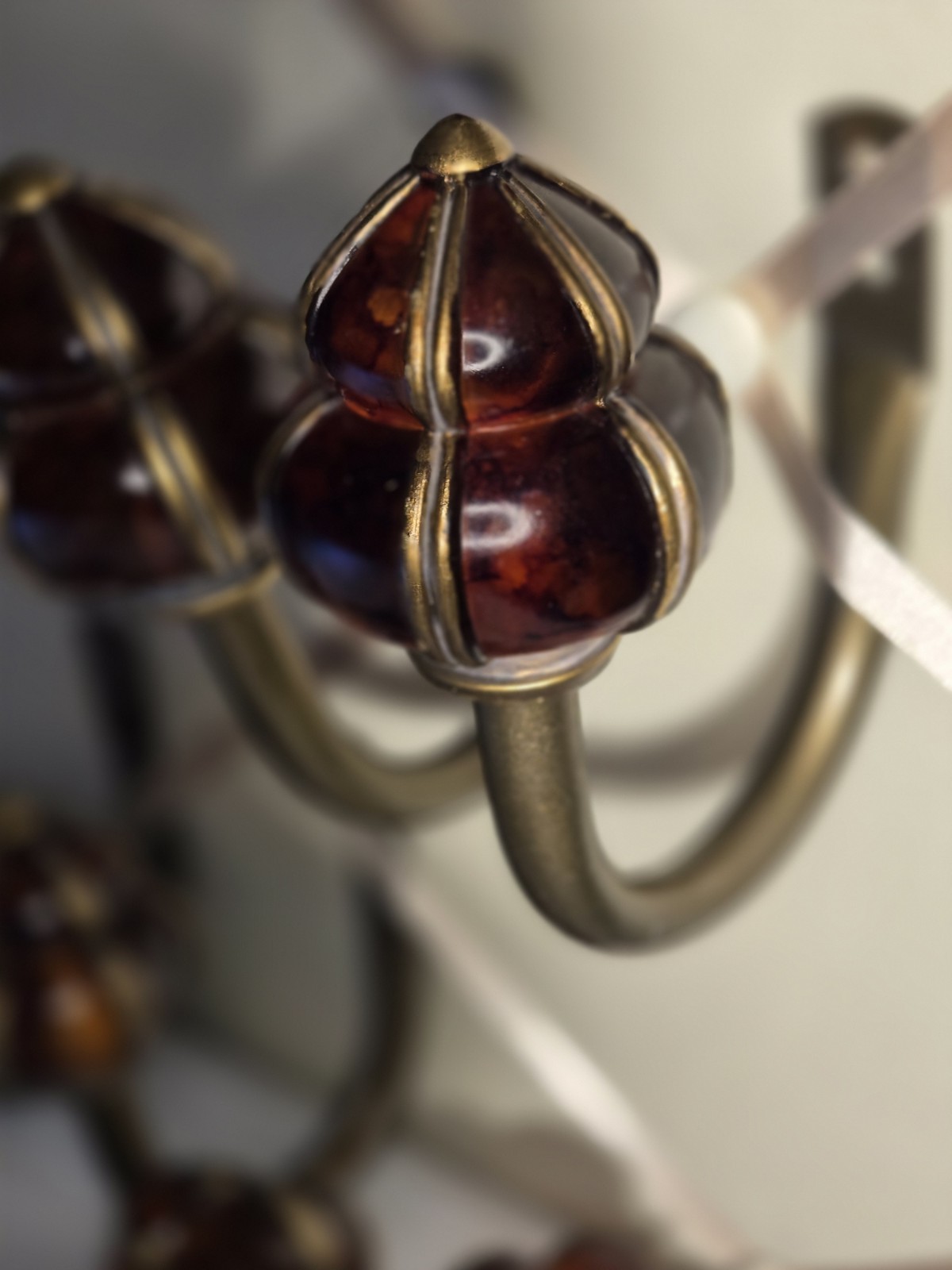 decorative wall curtain tie-back orange knob and a brass-finished metal arm