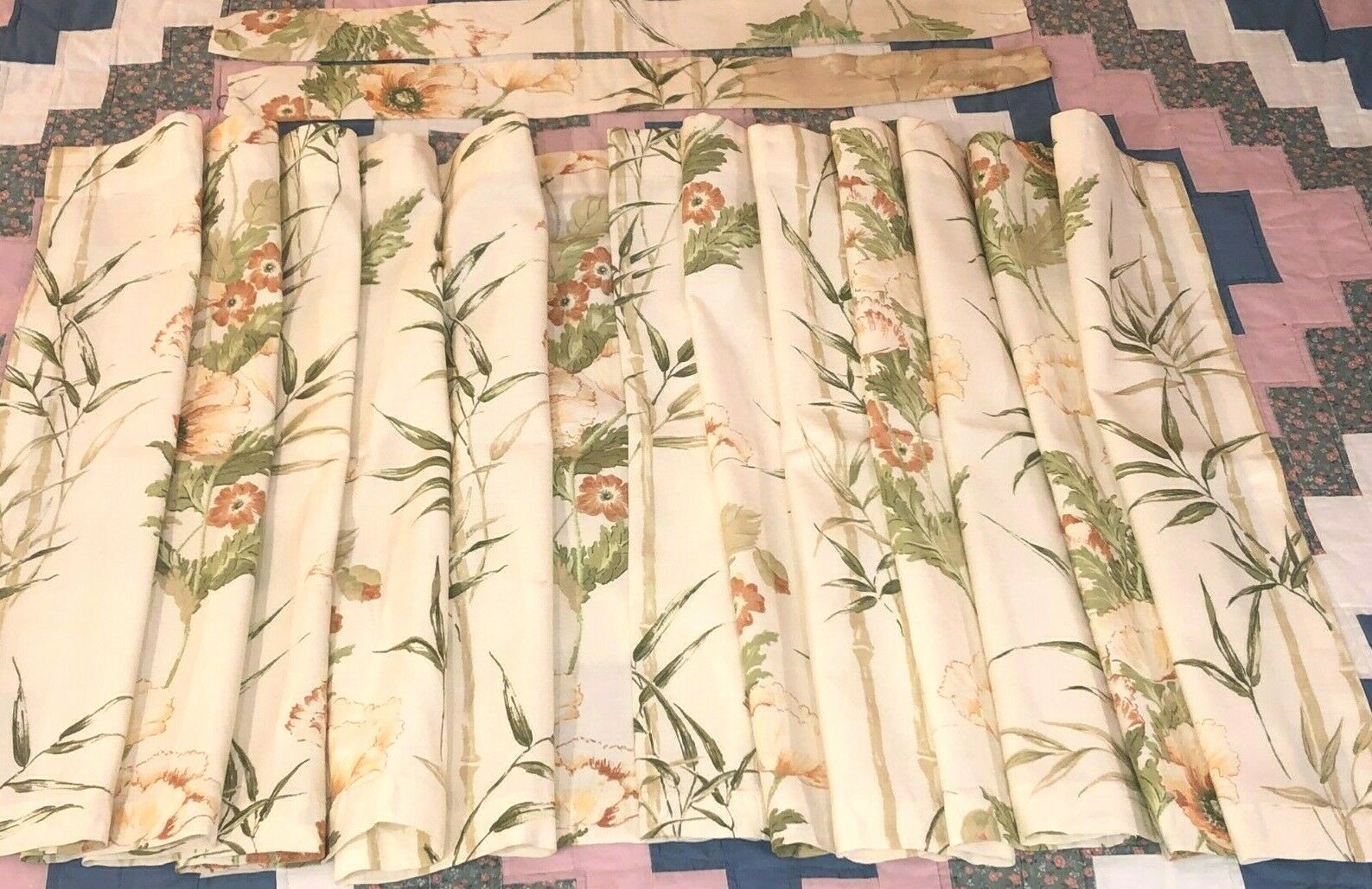 Valance of rose/green/cream floral print on synthetic fabric, rod pocket, 136″