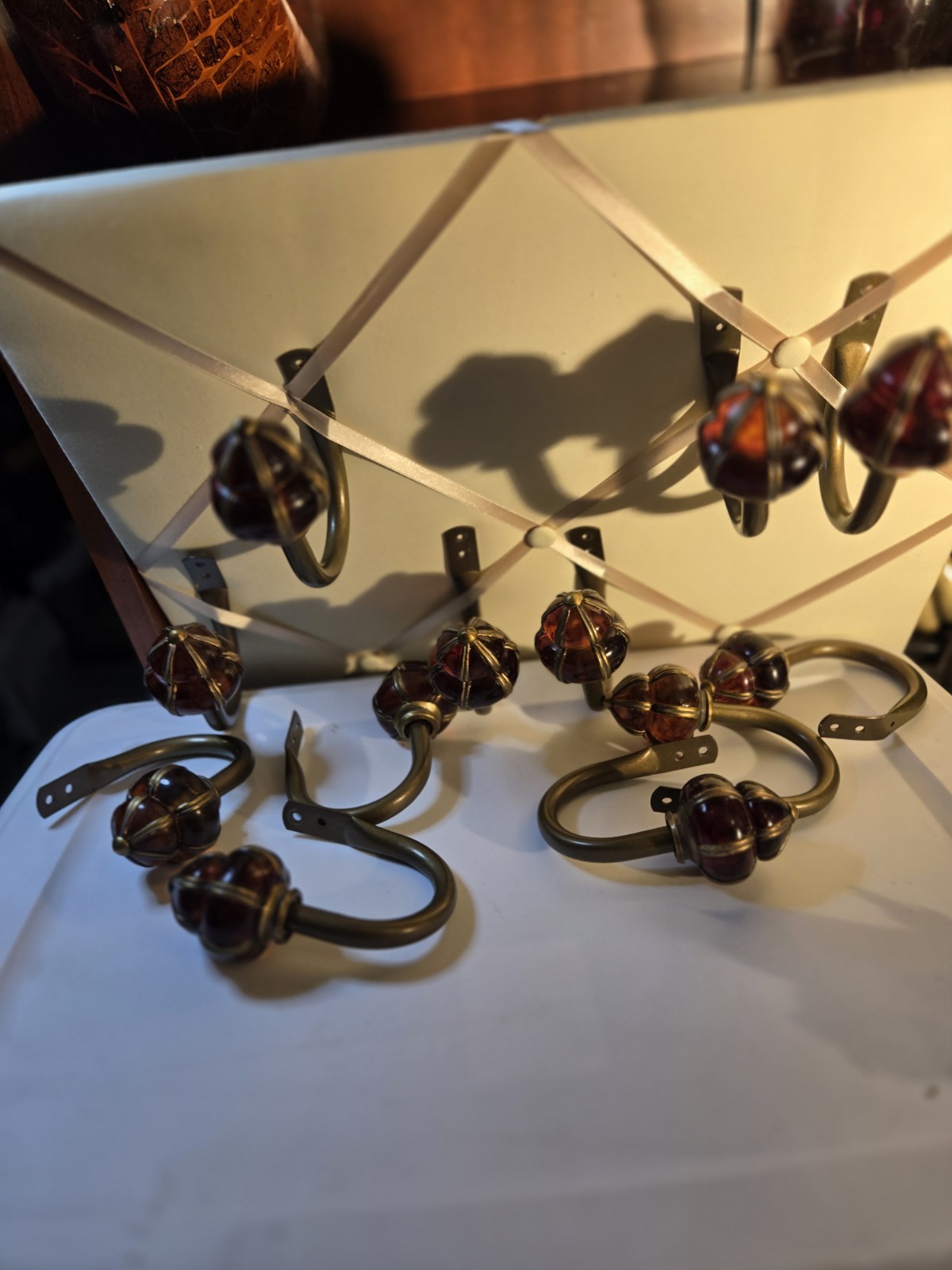 decorative wall curtain tie-back orange knob and a brass-finished metal arm