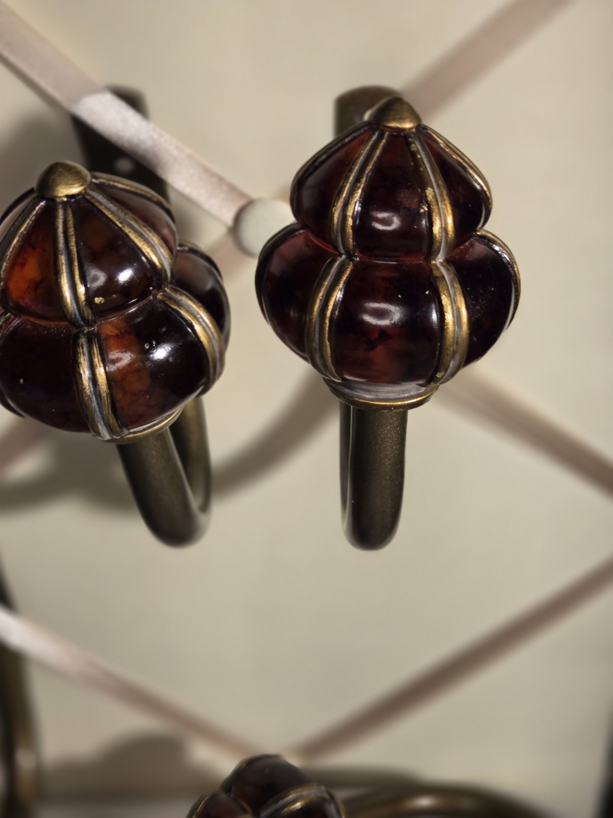 decorative wall curtain tie-back orange knob and a brass-finished metal arm