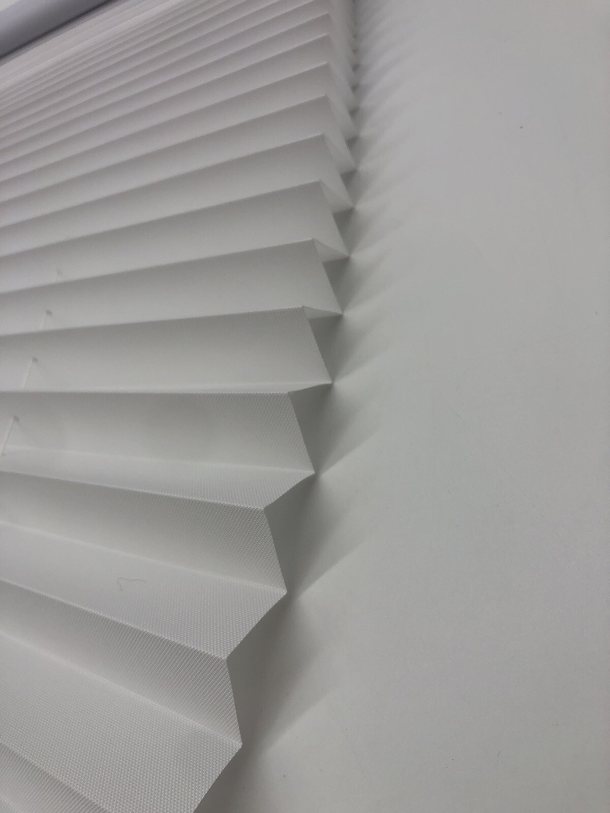 26in X 48in White Light Filtering Cordless Pleated Cellular shade.