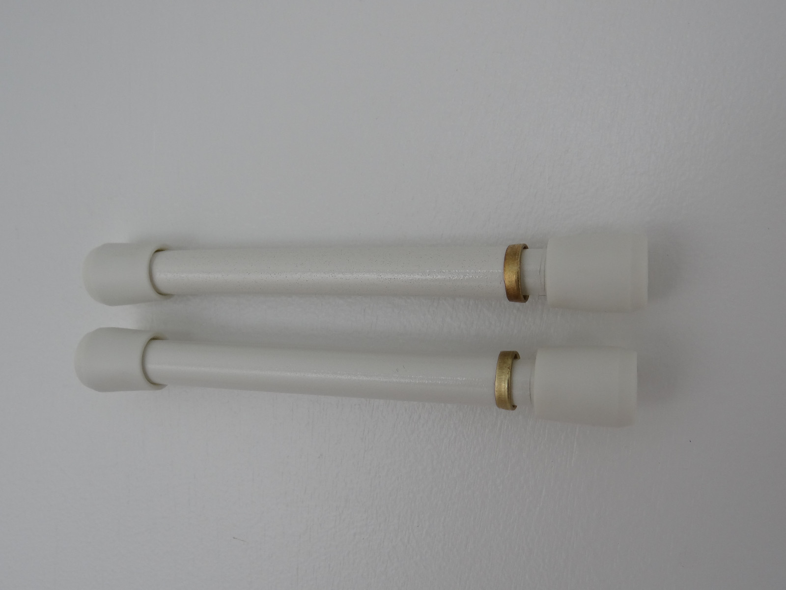 Spring Curtain Tension Rods White and Brass extend 5″ to 6 1/2″.